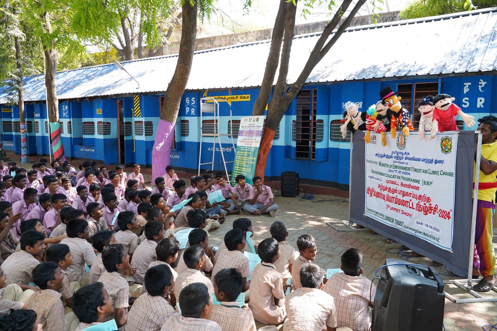 Village community gathered to watch the environmental folk performance.